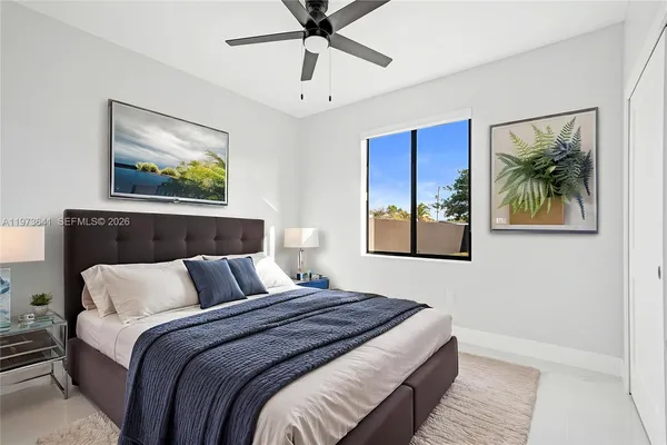 a bedroom with a large bed and a painting on the wall
