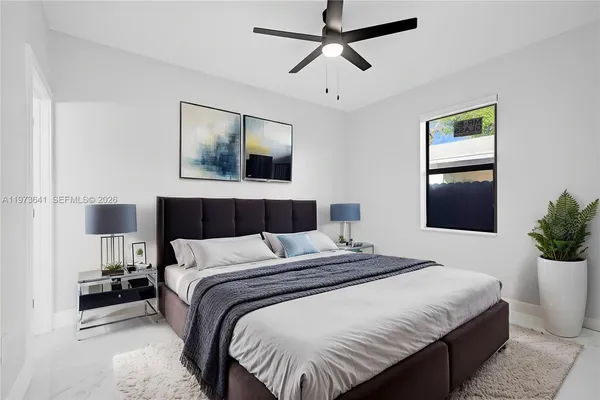 a bedroom with a large bed and a window