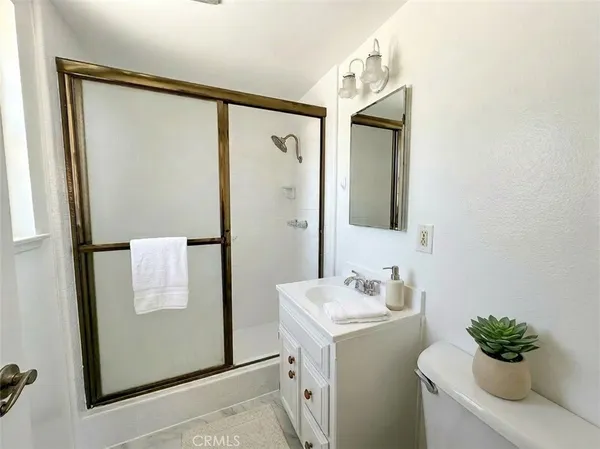 a bathroom with a sink a mirror and a shower