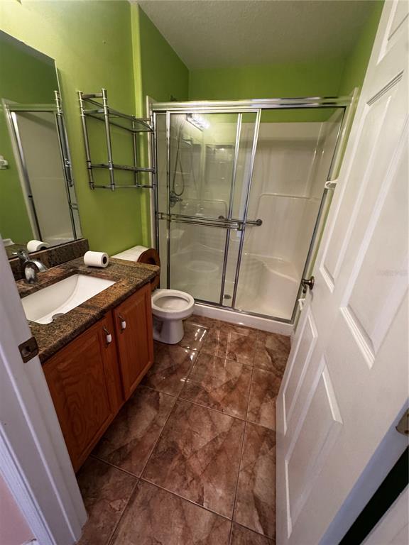 15296 Southwest 15th Terrace Road Ocala, FL 34473 - Photo 10 of 15 a bathroom with a granite countertop sink toilet and shower
