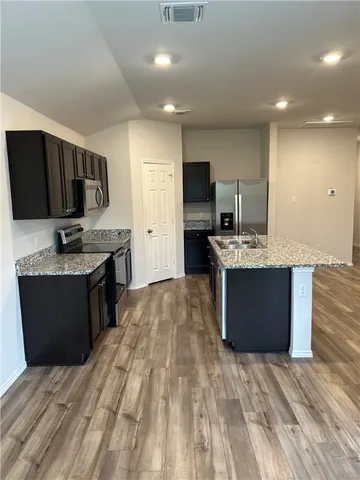 a kitchen with a stove top oven and sink