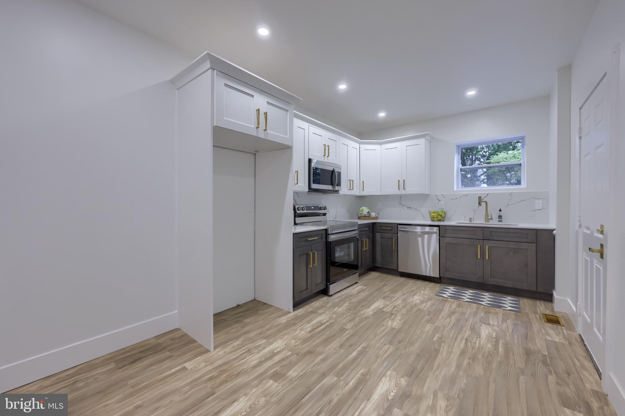 610 East Madison Street Lancaster, PA 17602 - Photo 11 of 68 a kitchen with granite countertop a sink cabinets and stainless steel appliances