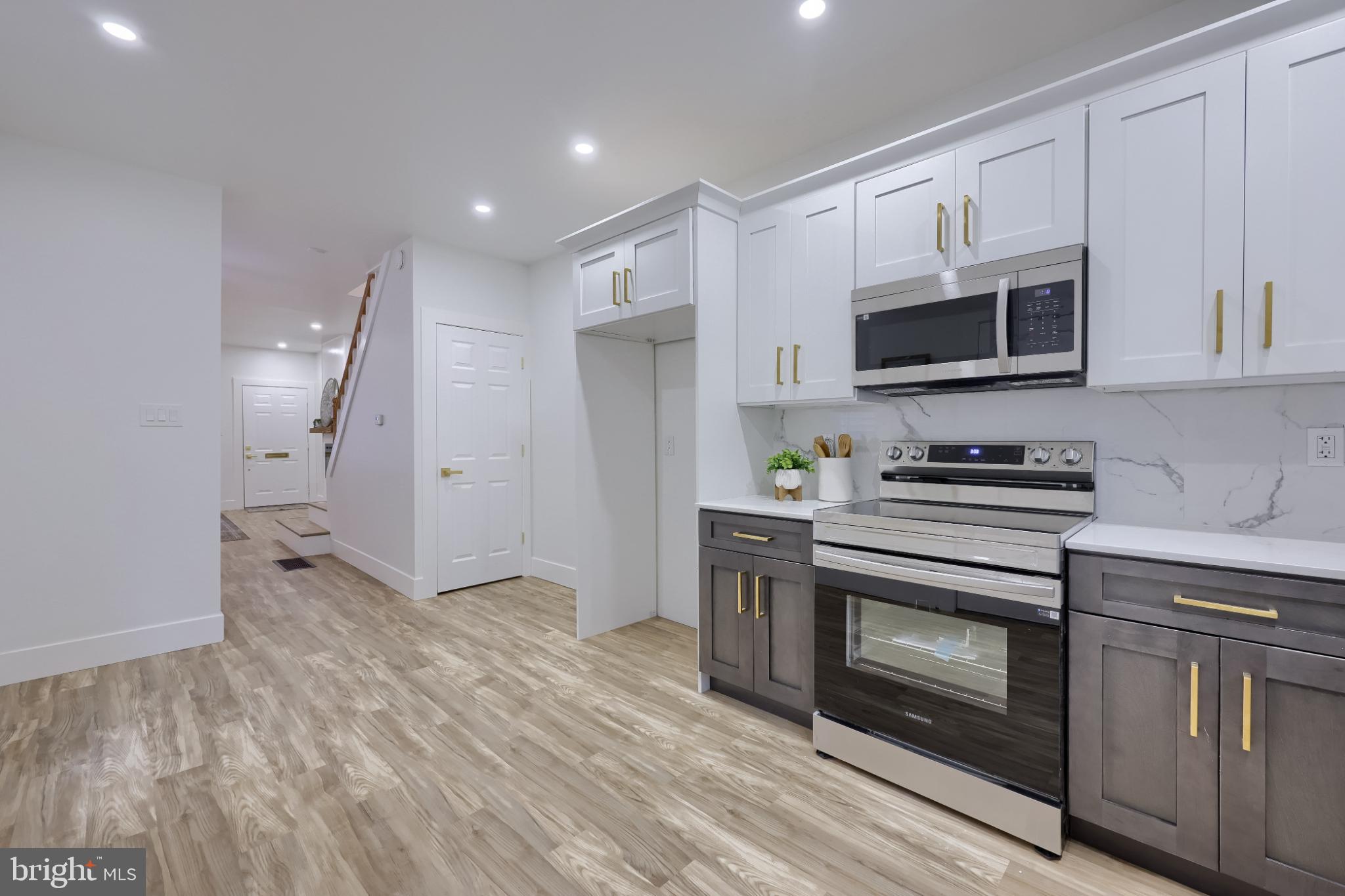 610 East Madison Street Lancaster, PA 17602 - Photo 13 of 68 a kitchen with stainless steel appliances granite countertop a stove a refrigerator and a microwave