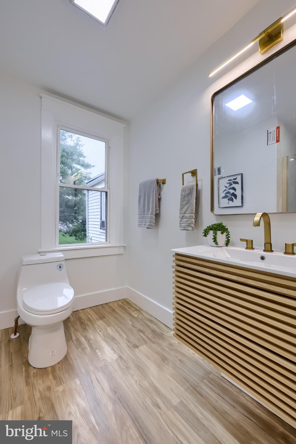 610 East Madison Street Lancaster, PA 17602 - Photo 21 of 68 a bathroom with a sink a toilet and a window
