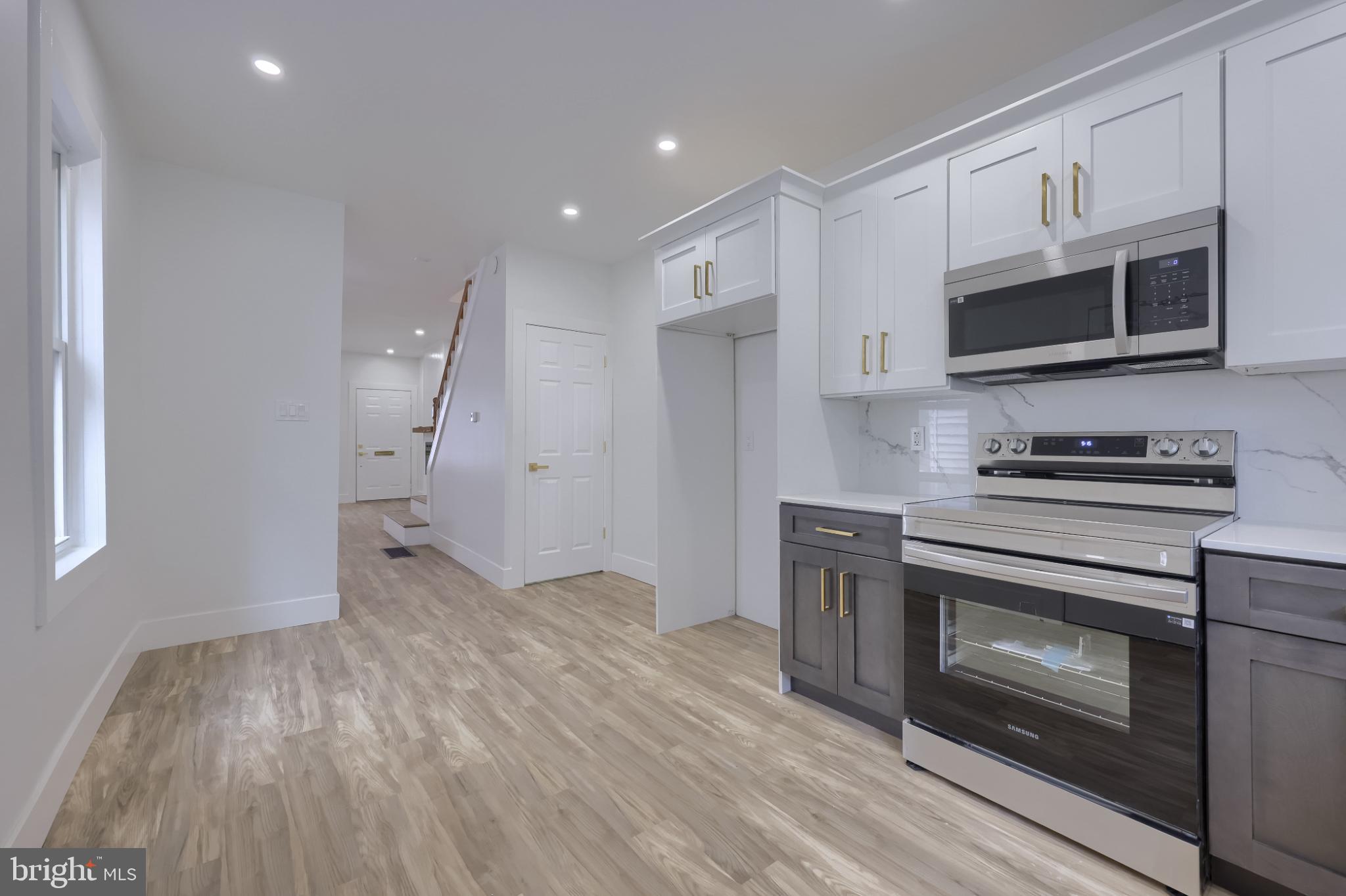 610 East Madison Street Lancaster, PA 17602 - Photo 42 of 68 a kitchen with stainless steel appliances a stove microwave and sink