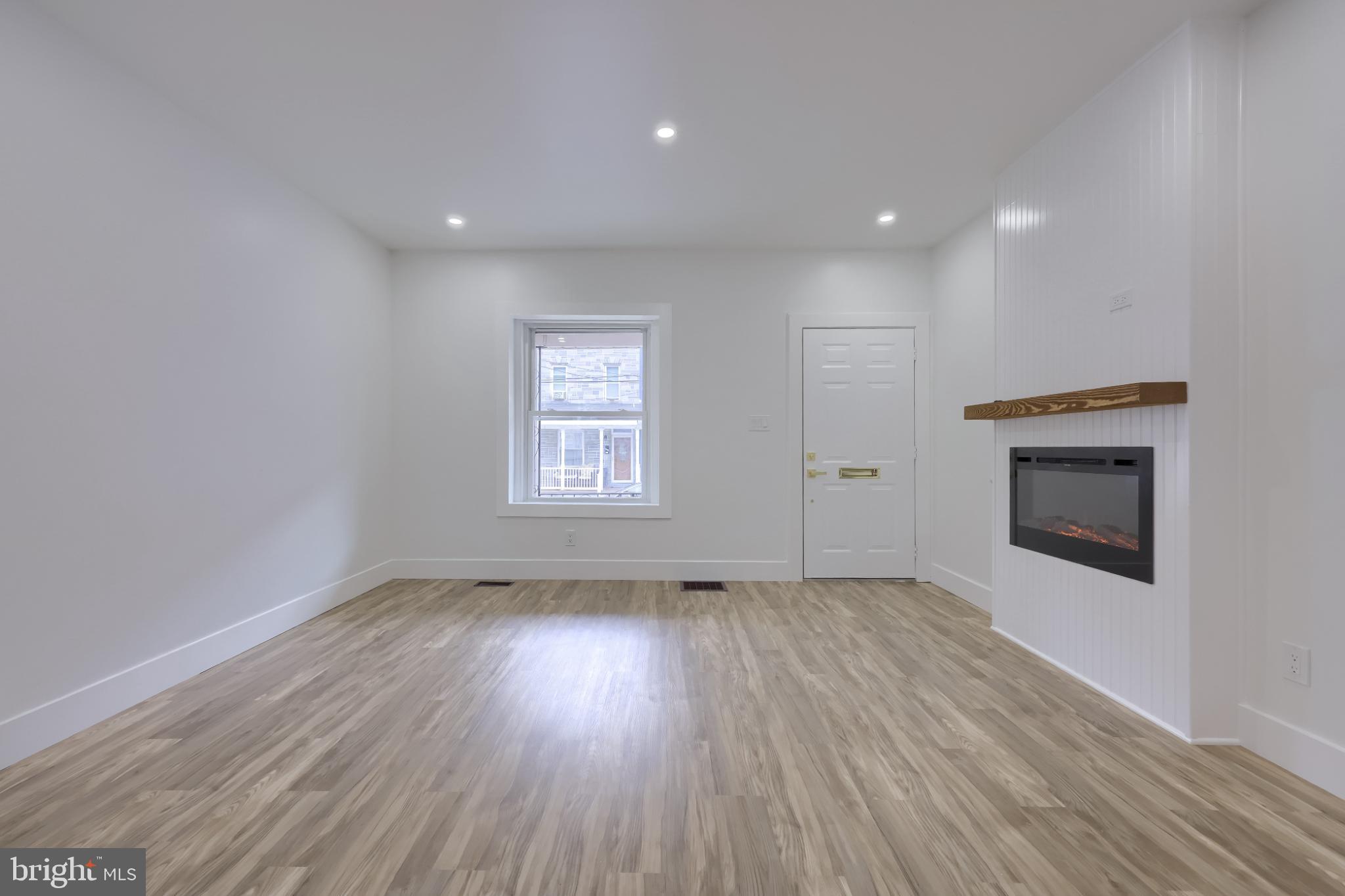 610 East Madison Street Lancaster, PA 17602 - Photo 46 of 68 an empty room with wooden floor and a fireplace