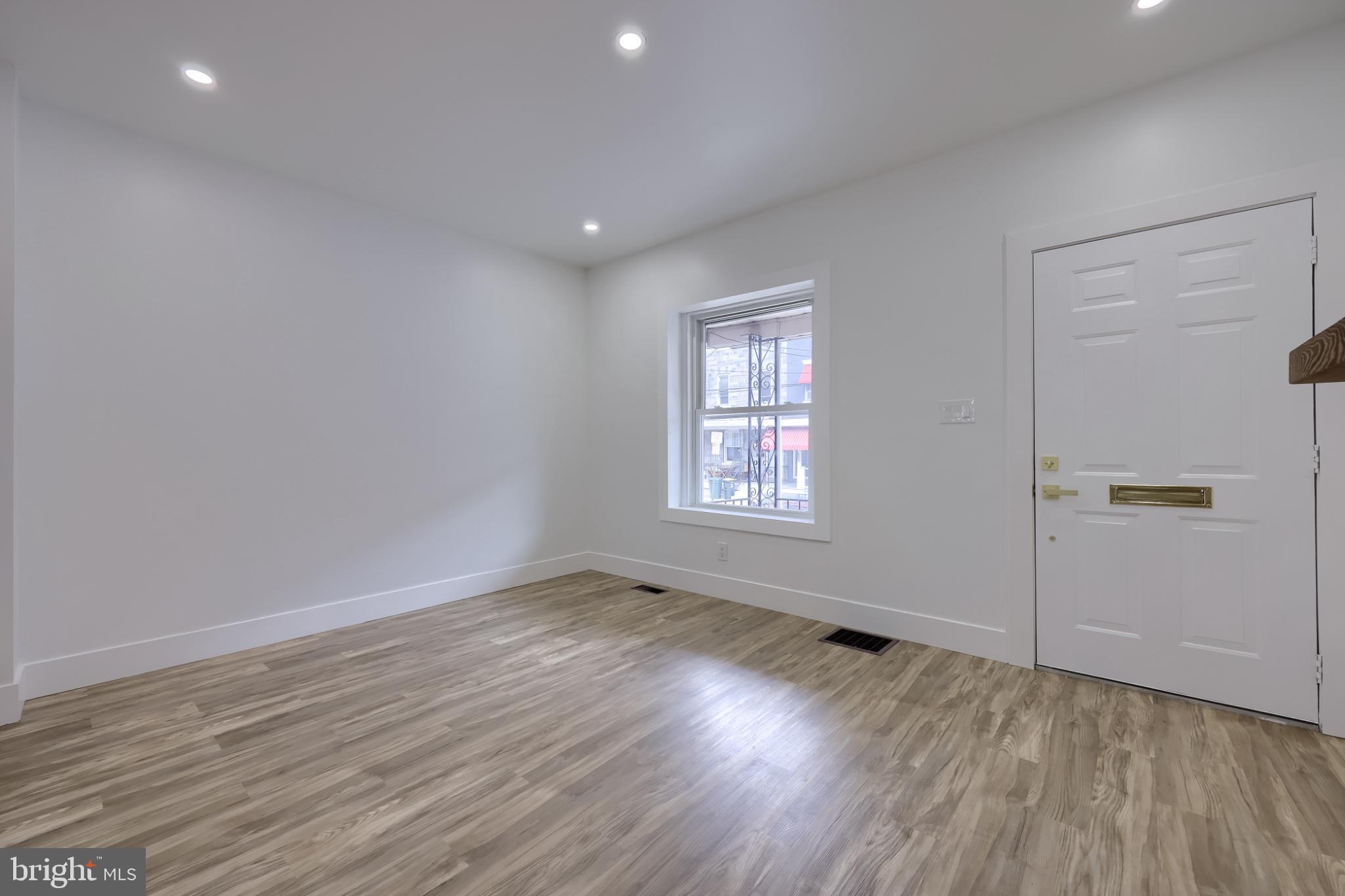 610 East Madison Street Lancaster, PA 17602 - Photo 48 of 68 an empty room with wooden floor and windows