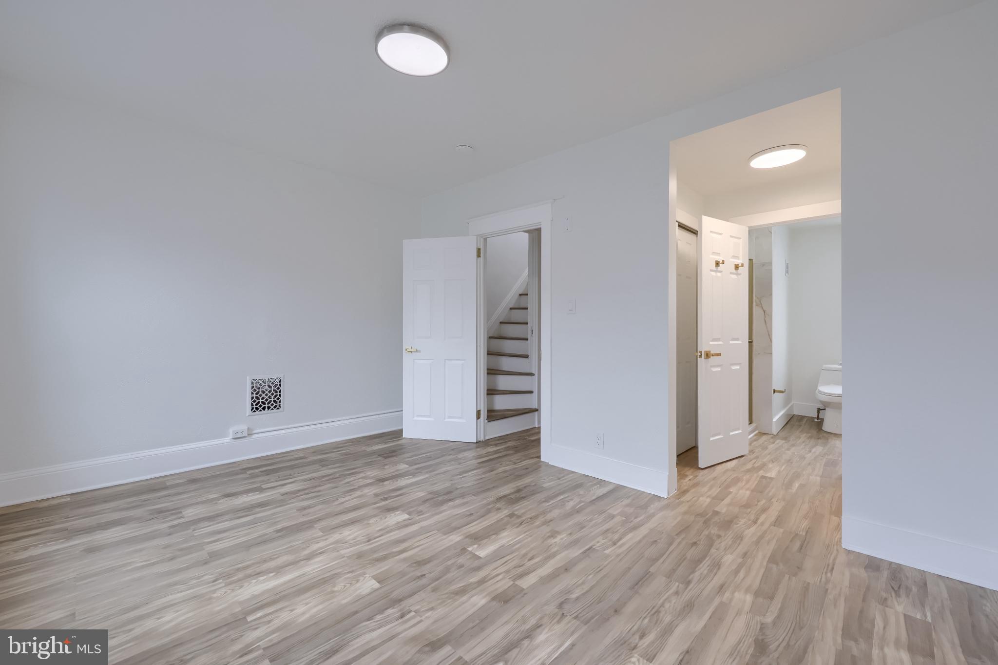 610 East Madison Street Lancaster, PA 17602 - Photo 65 of 68 a view of an empty room with wooden floor and a window