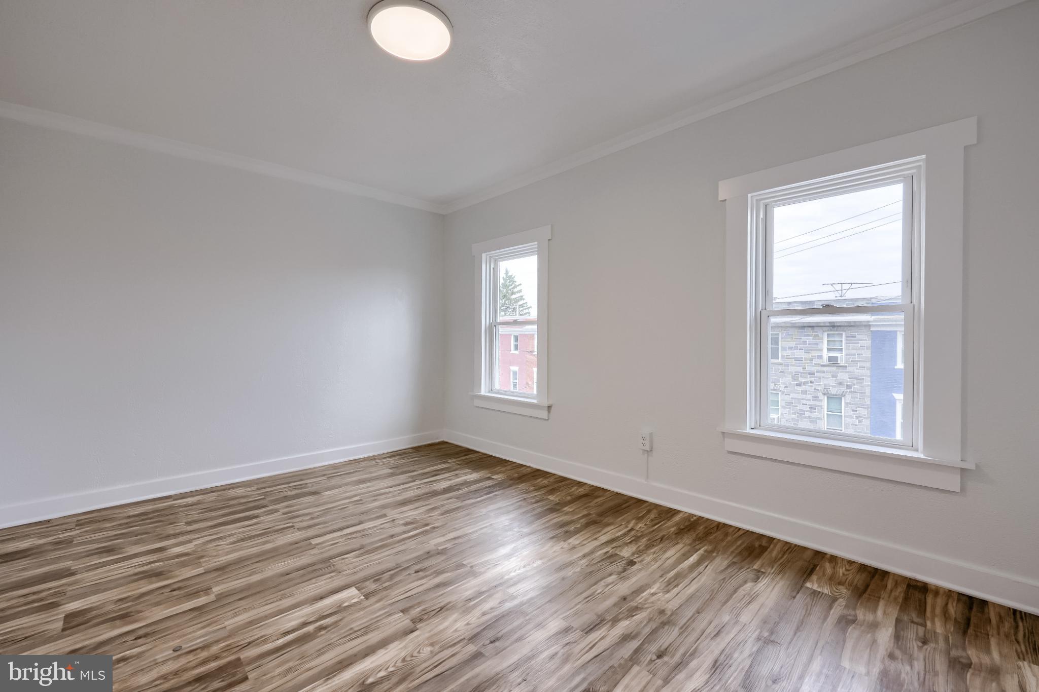 610 East Madison Street Lancaster, PA 17602 - Photo 67 of 68 a view of an empty room with wooden floor and a window