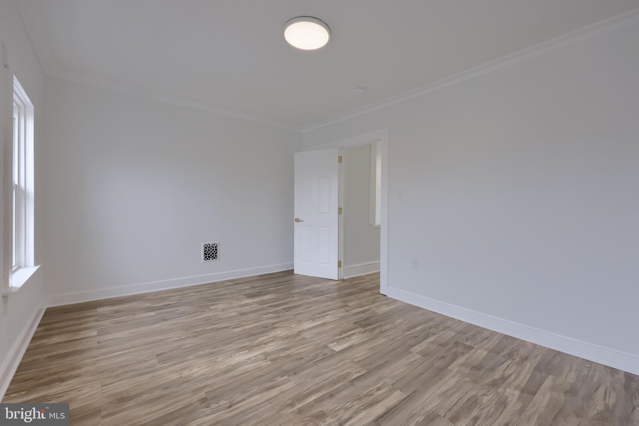 610 East Madison Street Lancaster, PA 17602 - Photo 68 of 68 a view of an empty room with wooden floor and a window