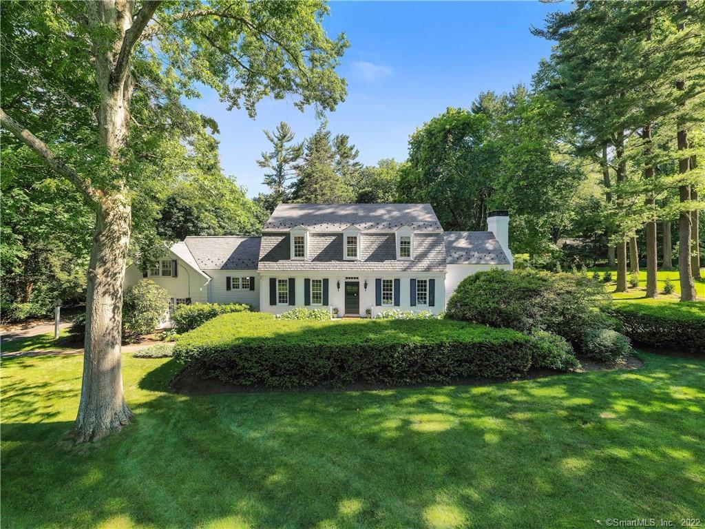20 Point O Woods Road Darien, CT 06820 - Photo 1 of 1 a front view of a house with a garden