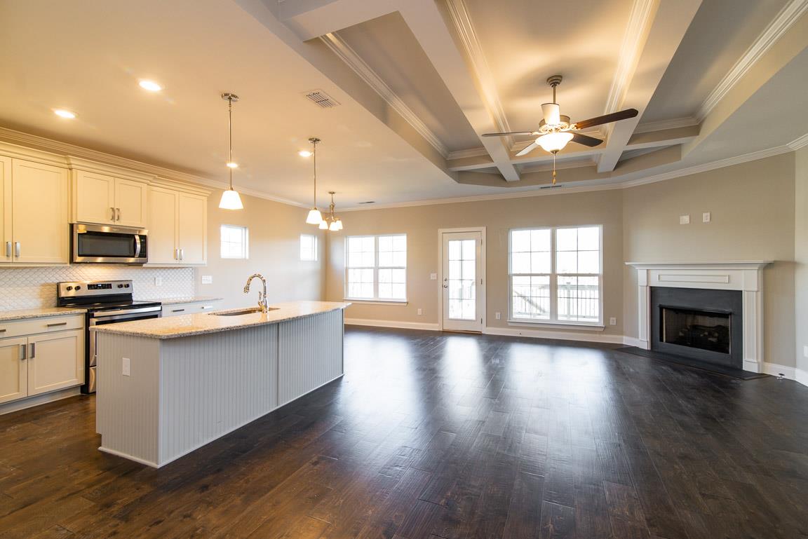 411 Butler Road Mount Juliet, TN 37122 - Photo 6 of 30 a large kitchen with stainless steel appliances granite countertop a stove oven a sink dishwasher and a fireplace with wooden floor