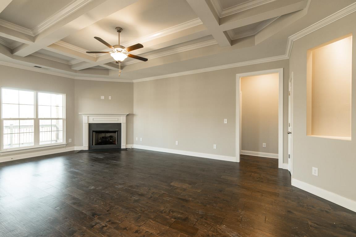 411 Butler Road Mount Juliet, TN 37122 - Photo 7 of 30 an empty room with wooden floor fan and windows