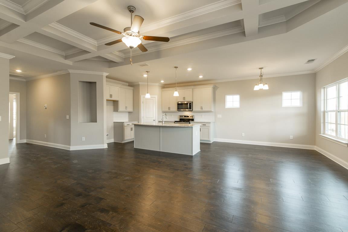 411 Butler Road Mount Juliet, TN 37122 - Photo 8 of 30 a view of an empty room and kitchen with wooden floor
