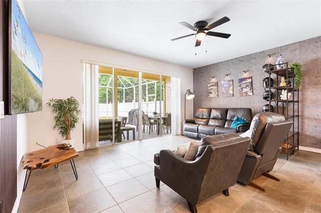 a living room with furniture and large windows