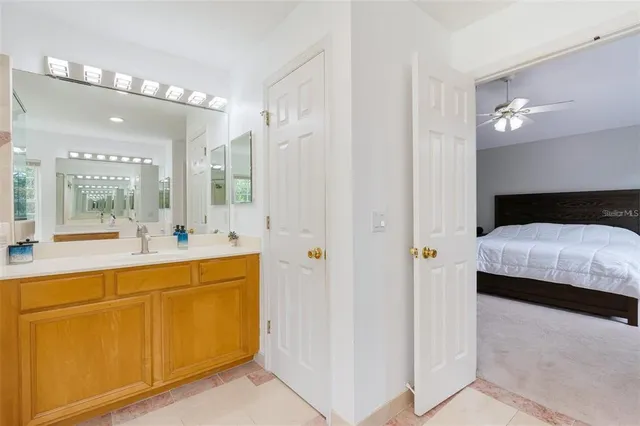 a en suite bathroom with a sink and a large mirror