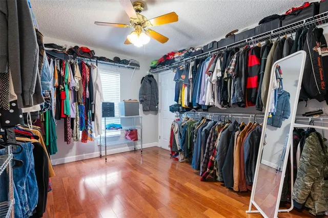 a view of walk in closet with clothes