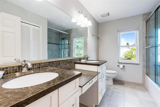 a bathroom with a sink double vanity and a toilet