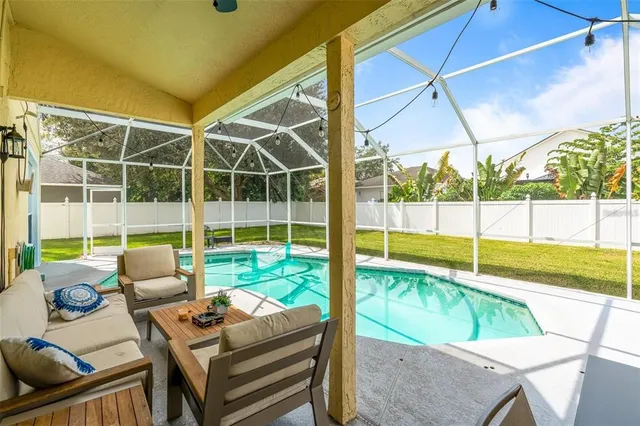 a view of swimming pool with seating area