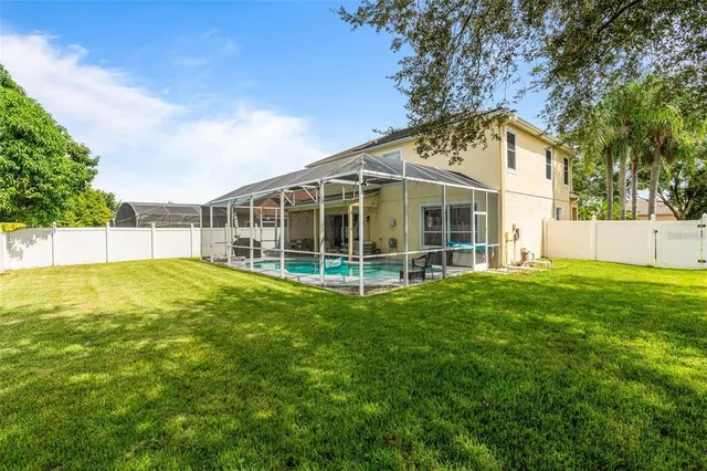 a view of a house with a backyard