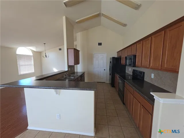 a view of a house with a ceiling fan and wooden floor