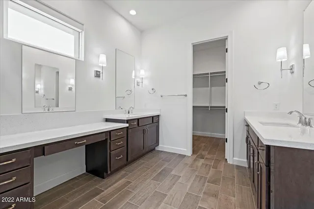 a spacious bathroom with a granite countertop sink and a mirror