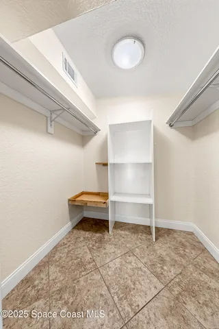 a view of empty room with ceiling fan