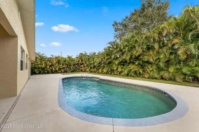 an aerial view of residential houses with outdoor space and parking