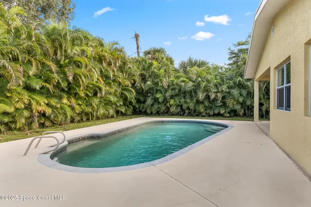 an aerial view of residential houses with outdoor space and street view