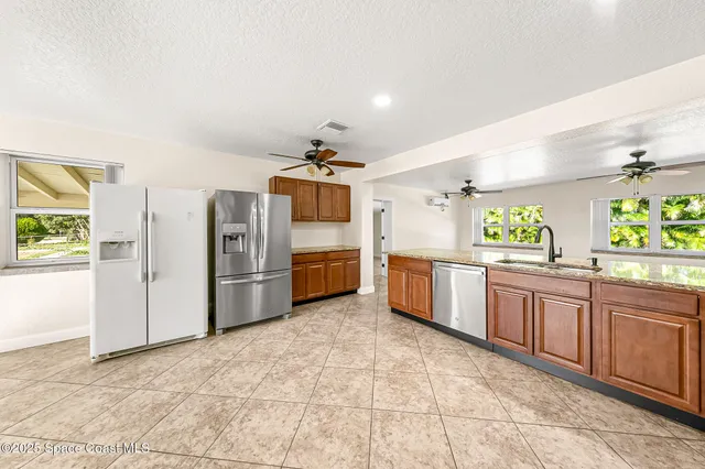 a view of a room with a ceiling fan