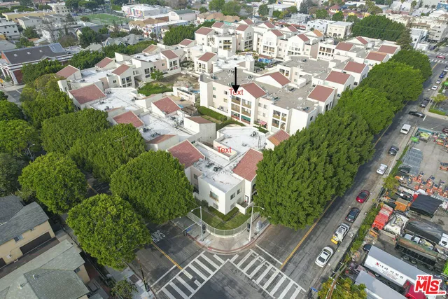 an aerial view of residential houses with yard