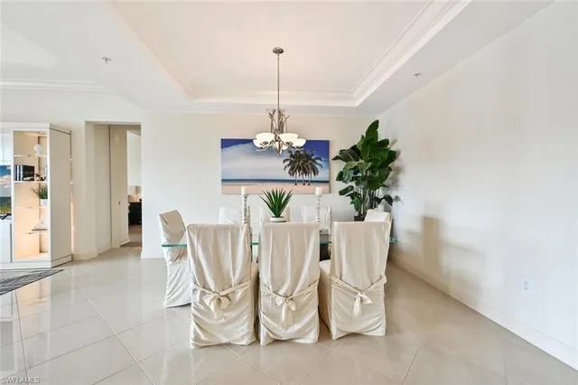 a dining room with furniture potted plants and wooden floor