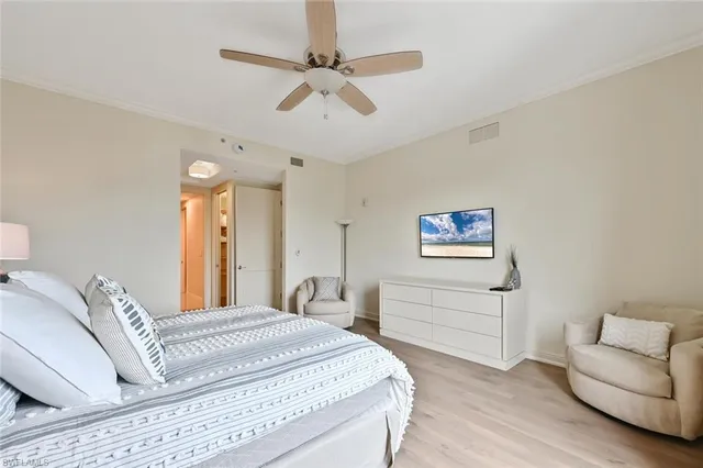 a spacious bedroom with a bed and a couch