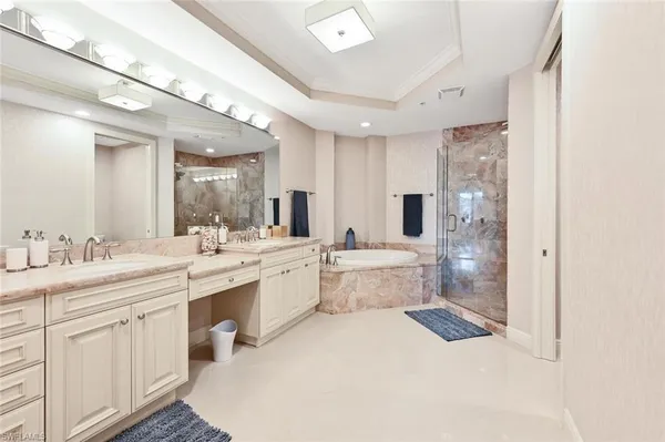 a large white room with a large window and stainless steel appliances
