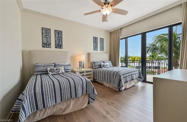a bedroom with two beds and a chandelier