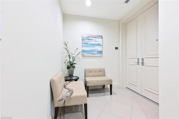 a living room with furniture and a painting