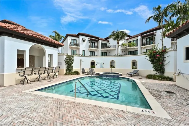a view of a house with pool porch and chairs