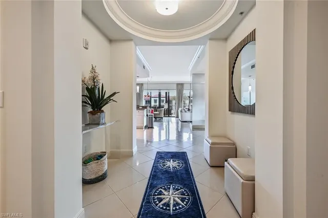 a hallway with wooden floor and a potted plant