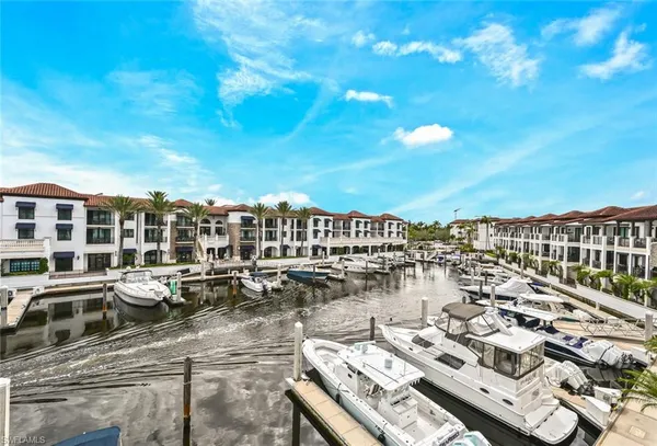 a view of a patio with dining table and chairs with a small yard