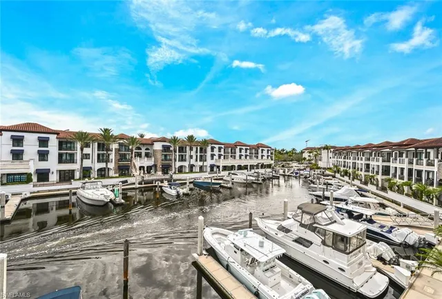 a view of a patio with dining table and chairs with a small yard