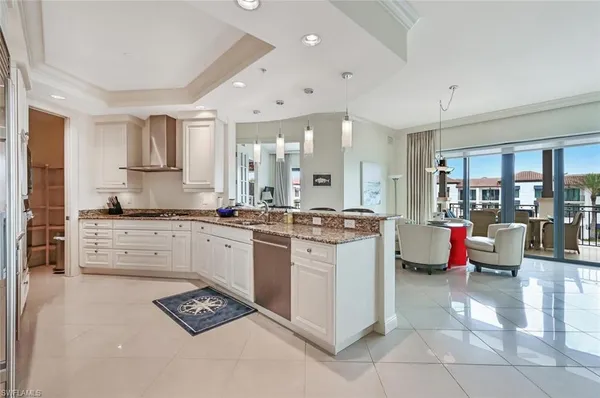 a kitchen with stainless steel appliances kitchen island granite countertop a sink and cabinets