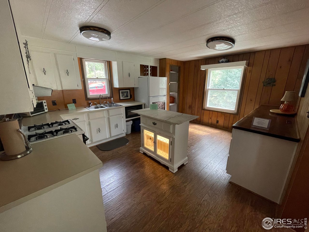 664 Riverside Drive Lyons, CO 80540 - Photo 5 of 16 a kitchen with a stove a sink and a refrigerator