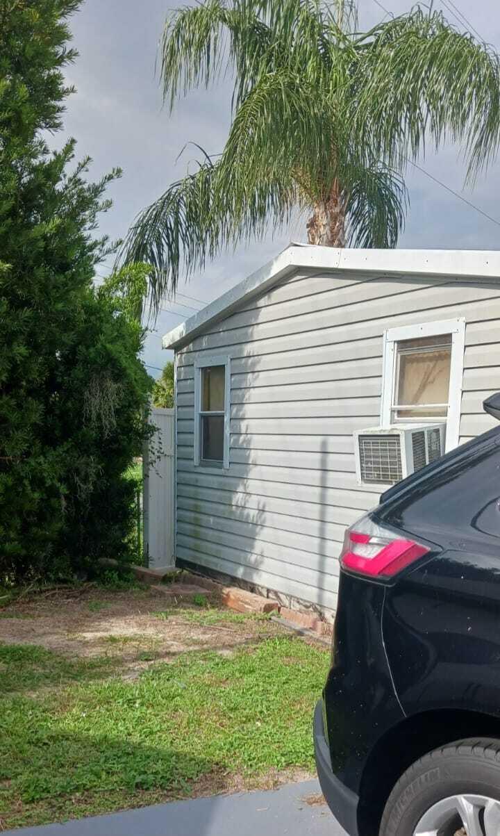 7950 Highway 78, Unit 7 Okeechobee, FL 34974 - Photo 2 of 10 a side view of a house with backyard