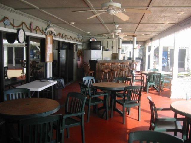 7950 Highway 78, Unit 7 Okeechobee, FL 34974 - Photo 7 of 10 a view of a dining room with furniture and chandelier