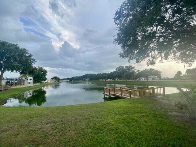 7950 Highway 78, Unit 7 Okeechobee, FL 34974 - Photo 9 of 10 a lake view with a garden