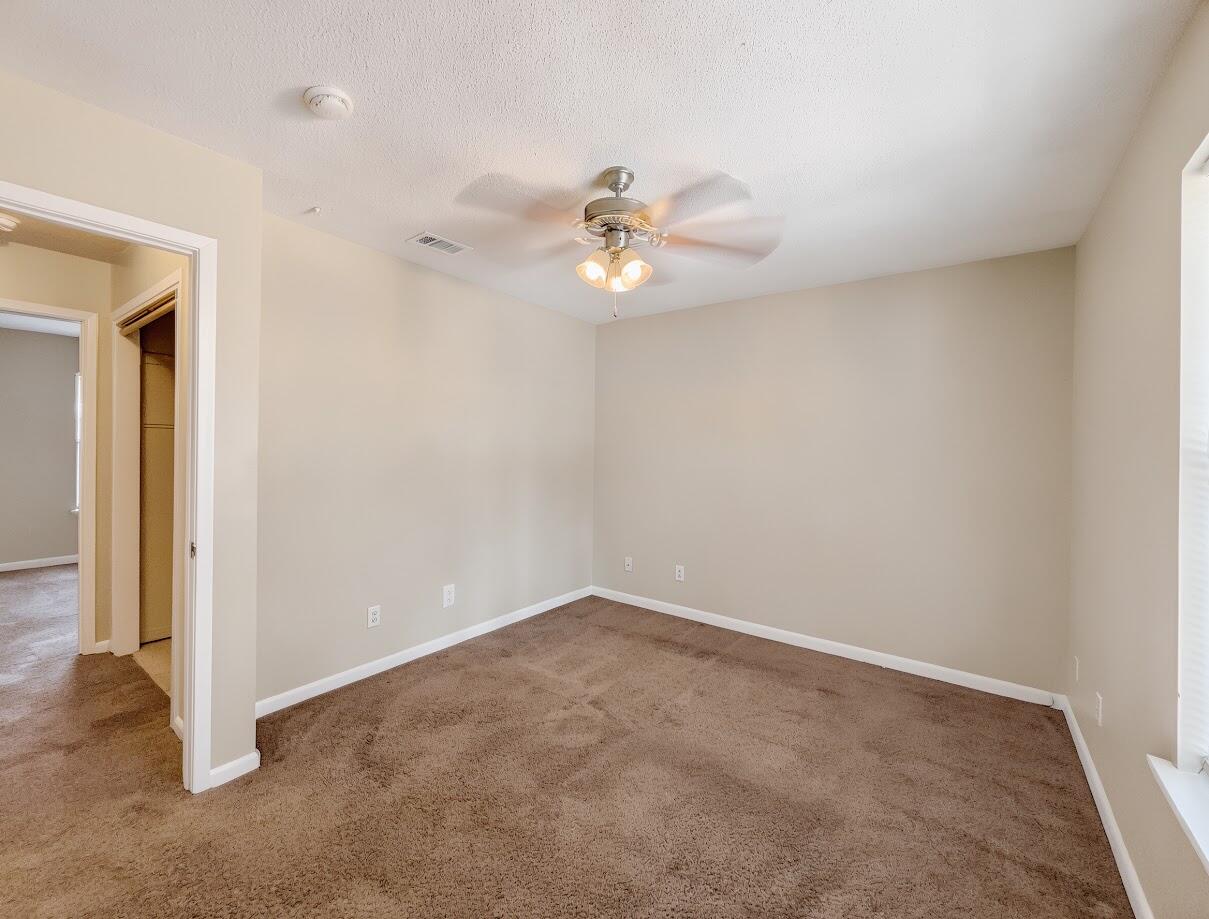 208 Squirrel Haven Road, Unit A Mary Esther, FL 32569 - Photo 11 of 16 an empty room with a ceiling fan and a window