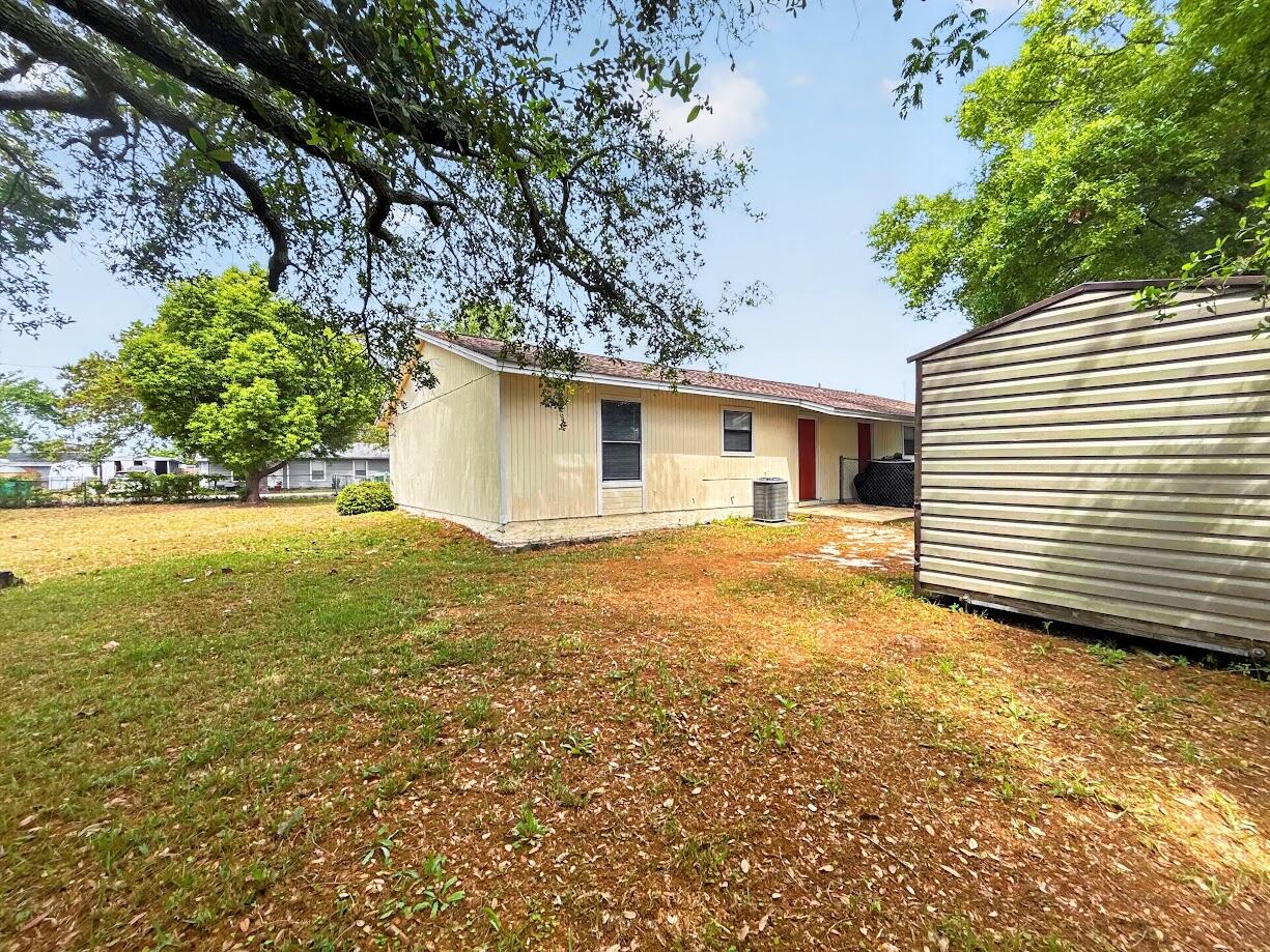 208 Squirrel Haven Road, Unit A Mary Esther, FL 32569 - Photo 13 of 16 a view of a backyard with a garden