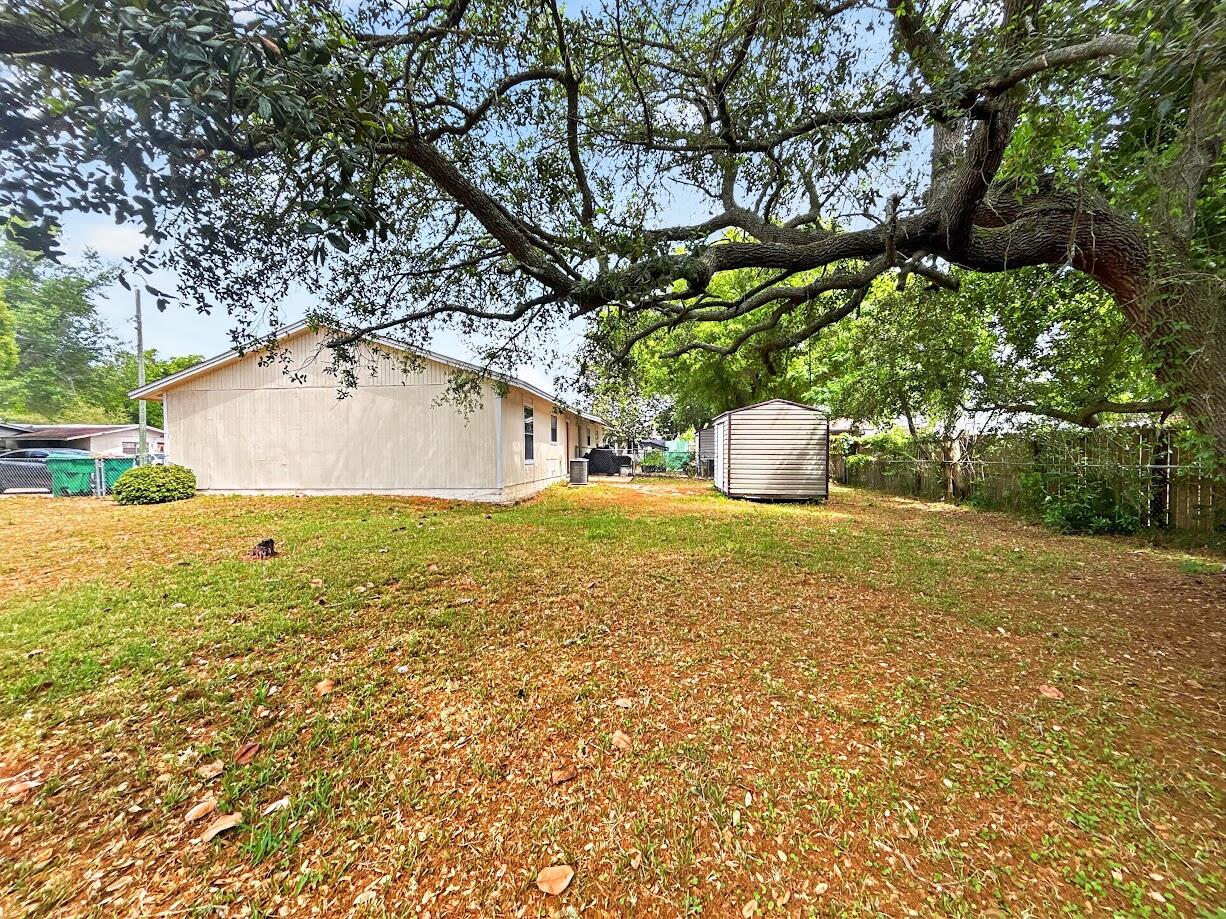 208 Squirrel Haven Road, Unit A Mary Esther, FL 32569 - Photo 14 of 16 a view of a house with a yard