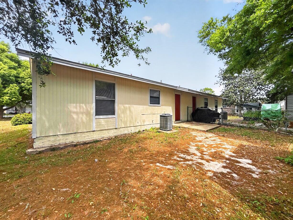 208 Squirrel Haven Road, Unit A Mary Esther, FL 32569 - Photo 16 of 16 a front view of a house with a yard and garage