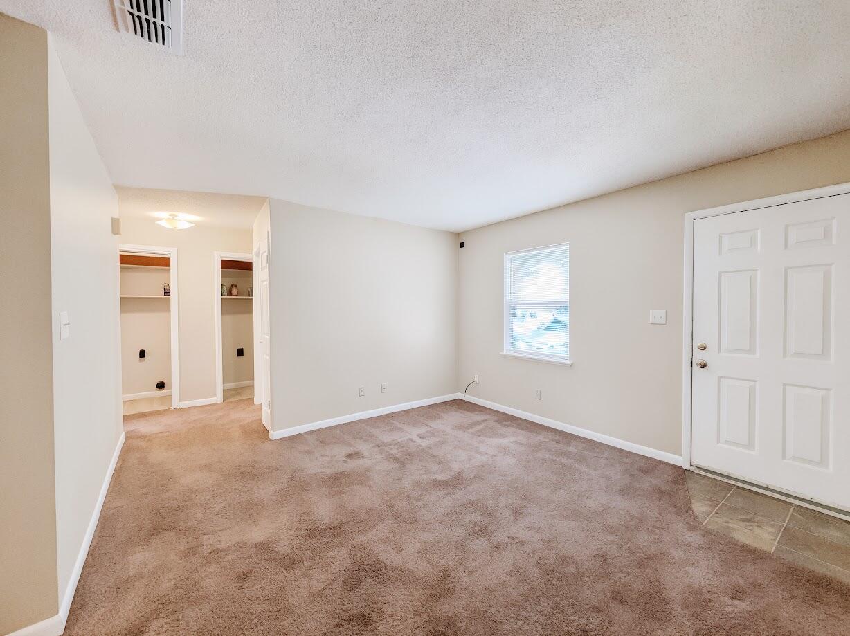 208 Squirrel Haven Road, Unit A Mary Esther, FL 32569 - Photo 4 of 16 an empty room with windows and closet
